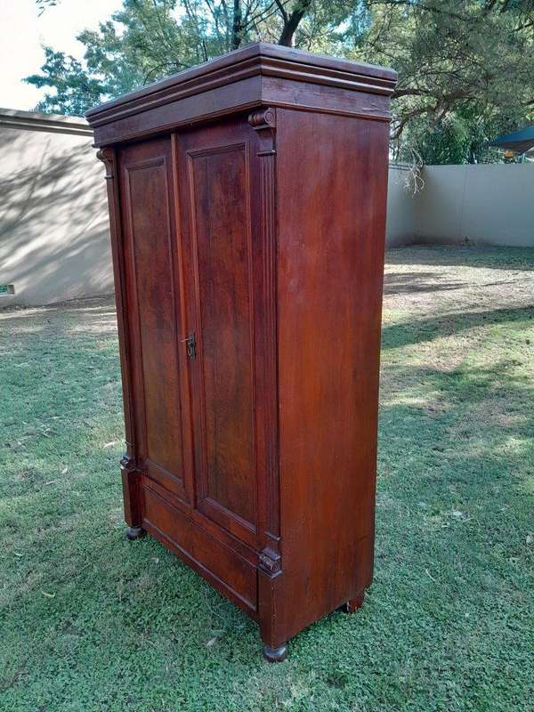 A Mid  20th Century Stinkwood Linen Press with Four Original Shelves and Drawers