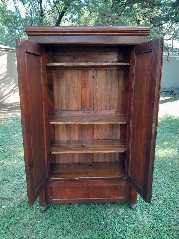 A Mid  20th Century Stinkwood Linen Press with Four Original Shelves and Drawers