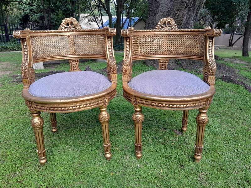 A Pair of French Louis XVI Style Carved and Rattan Chairs