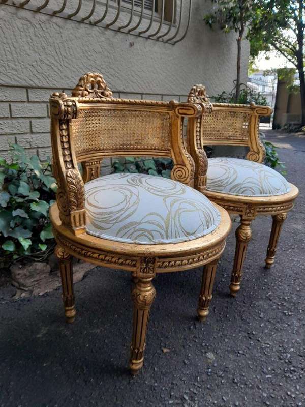 A Pair Of French Louis XVI Style Carved And Hand Gilded  Rattan Chairs Upholstered In A Custom M...