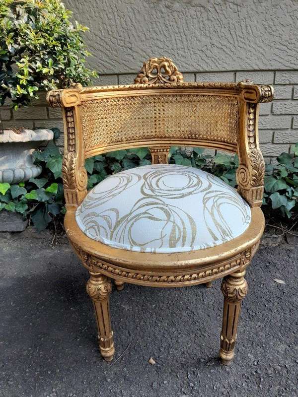 A Pair Of French Louis XVI Style Carved And Hand Gilded  Rattan Chairs Upholstered In A Custom M...