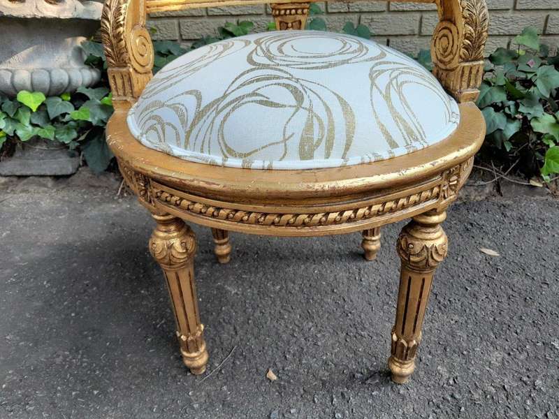 A Pair Of French Louis XVI Style Carved And Hand Gilded  Rattan Chairs Upholstered In A Custom M...