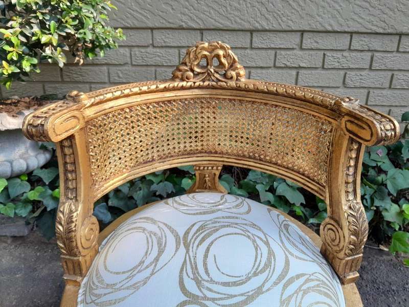 A Pair Of French Louis XVI Style Carved And Hand Gilded  Rattan Chairs Upholstered In A Custom M...