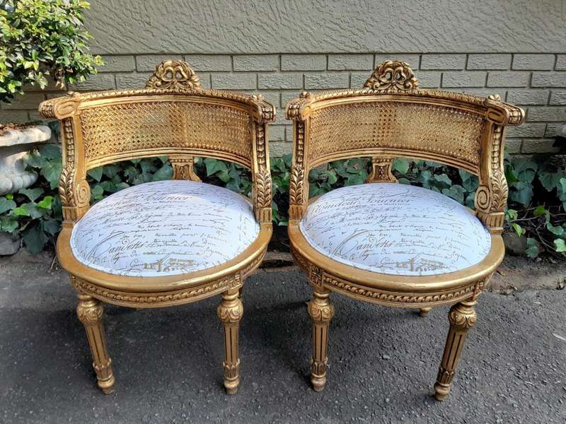 A Pair Of French Louis XVI Style Carved And Hand Gilded  Rattan Chairs Upholstered In A Custom M...