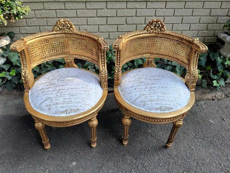 A Pair Of French Louis XVI Style Carved And Hand Gilded  Rattan Chairs Upholstered In A Custom M...