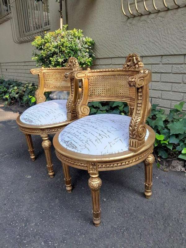 A Pair Of French Louis XVI Style Carved And Hand Gilded  Rattan Chairs Upholstered In A Custom M...