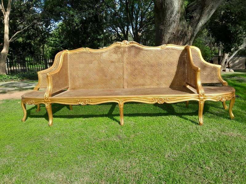 A 20th Century French Style Carved and Gilded Conversation Settee in Rattan