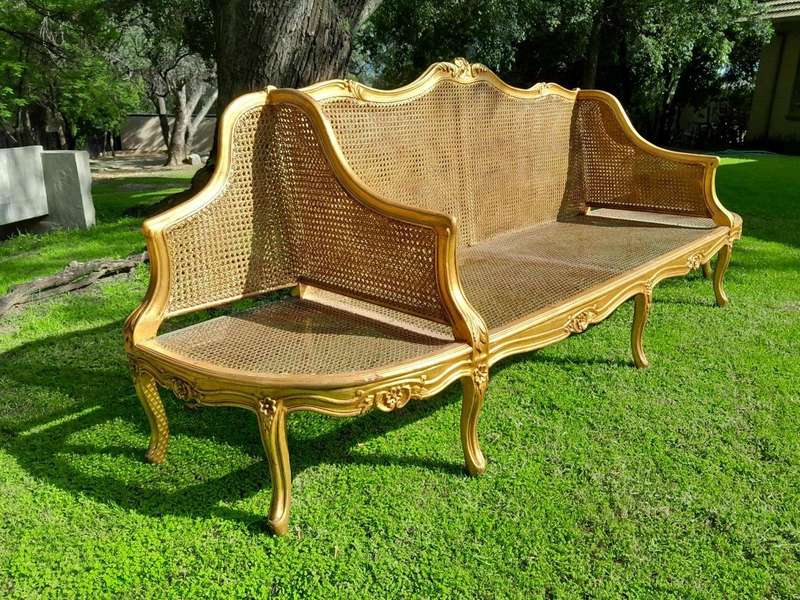 A 20th Century French Style Carved and Gilded Conversation Settee in Rattan