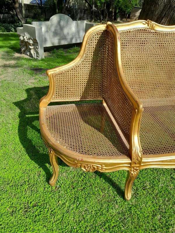 A 20th Century French Style Carved and Gilded Conversation Settee in Rattan