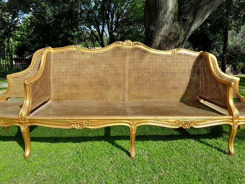 A 20th Century French Style Carved and Gilded Conversation Settee in Rattan