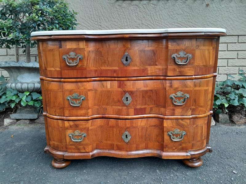 An Antique 19th Century Walnut Bombe Chest of Drawers With Brass Hardware