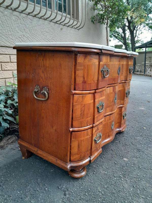 An Antique 19th Century Walnut Bombe Chest of Drawers With Brass Hardware