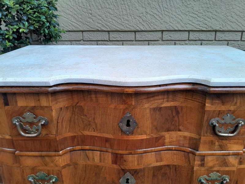 An Antique 19th Century Walnut Bombe Chest of Drawers With Brass Hardware