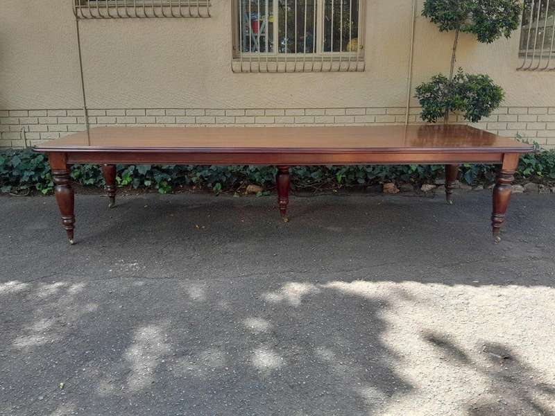 A 20th Century Victorian Style Mahogany Dining Table of Large Proportions on Castors with 5 legs...