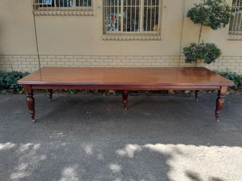 A 20th Century Victorian Style Mahogany Dining Table of Large Proportions on Castors with 5 legs...