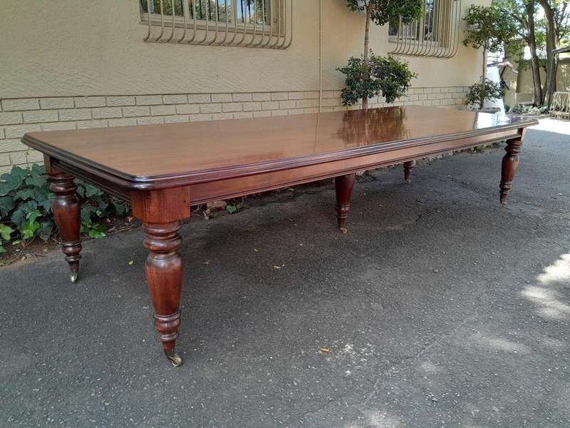 A 20th Century Victorian Style Mahogany Dining Table of Large Proportions on Castors with 5 legs...
