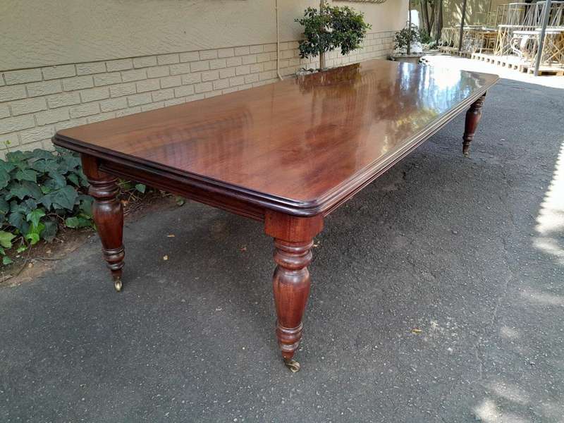 A 20th Century Victorian Style Mahogany Dining Table of Large Proportions on Castors with 5 legs...