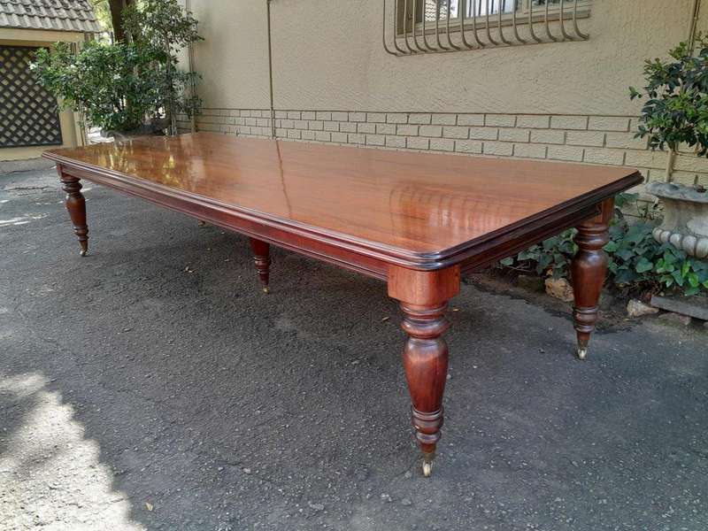 A 20th Century Victorian Style Mahogany Dining Table of Large Proportions on Castors with 5 legs...