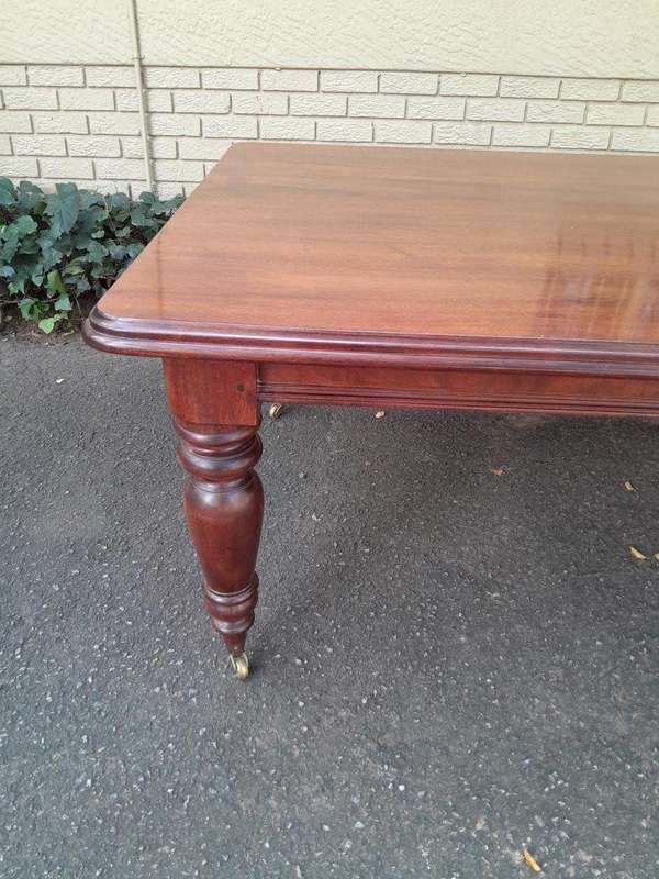 A 20th Century Victorian Style Mahogany Dining Table of Large Proportions on Castors with 5 legs...