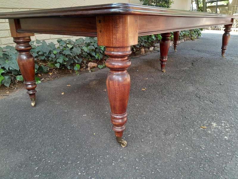 A 20th Century Victorian Style Mahogany Dining Table of Large Proportions on Castors with 5 legs...