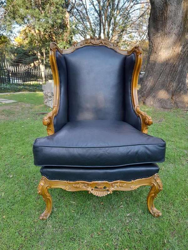 A 20th Century Pair Of French Louis XVI Style Carved Wingback Armchairs