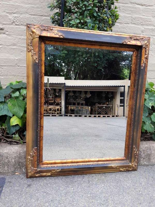 A 20TH Century Pair of Victorian Style Gilt Painted and Walnut Bevelled Mirrors