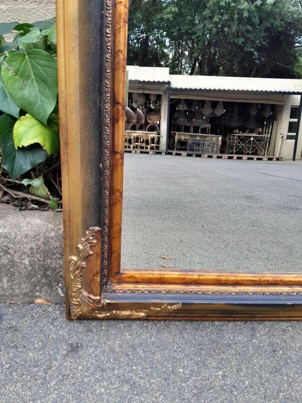 A 20TH Century Pair of Victorian Style Gilt Painted and Walnut Bevelled Mirrors