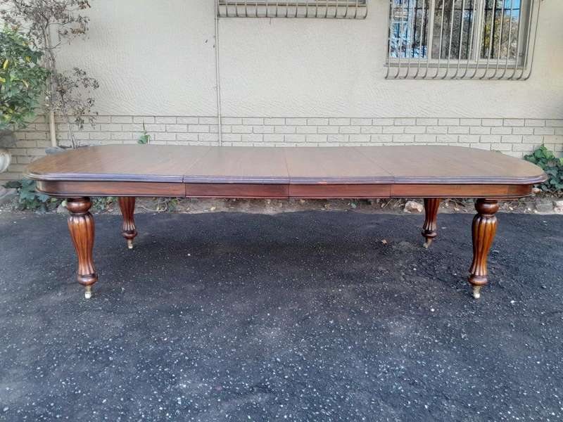 A Massive Antique Circa 1880 Victorian Carved Mahogany Dining Table With Two Extensions On Castor...