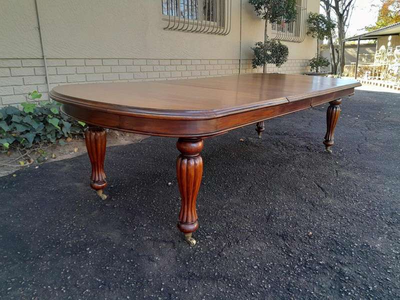 A Massive Antique Circa 1880 Victorian Carved Mahogany Dining Table With Two Extensions On Castor...