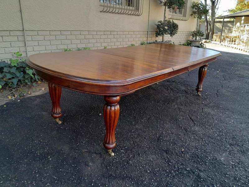 A Massive Antique Circa 1880 Victorian Carved Mahogany Dining Table With Two Extensions On Castor...