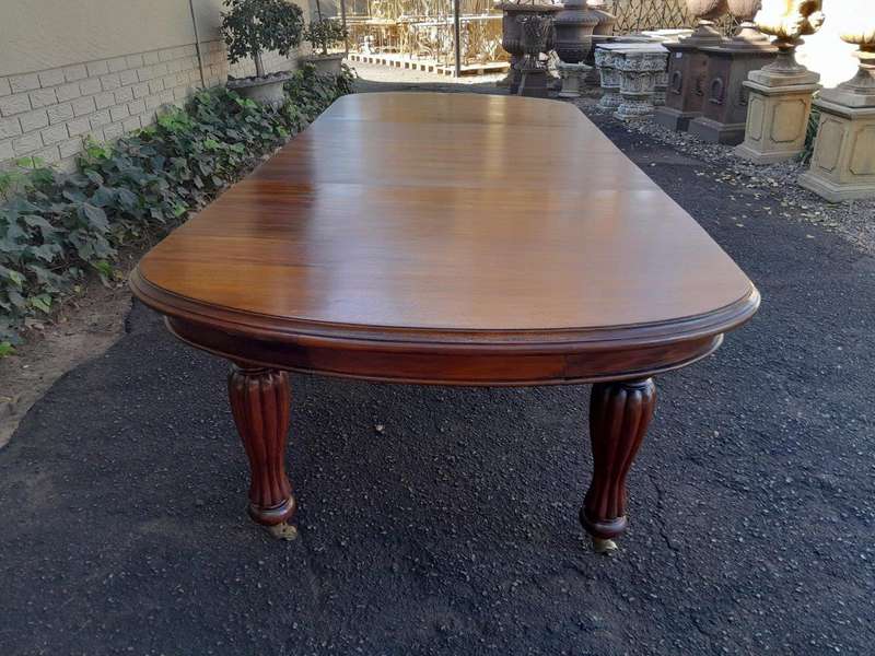 A Massive Antique Circa 1880 Victorian Carved Mahogany Dining Table With Two Extensions On Castor...