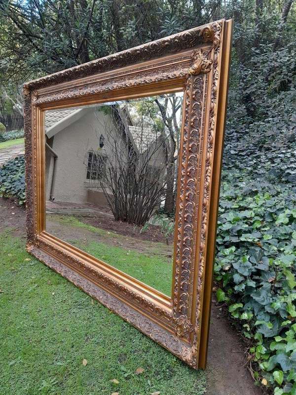 A 20th Century Heavily Carved And Bevelled Framed Mirror Of Large Proportions