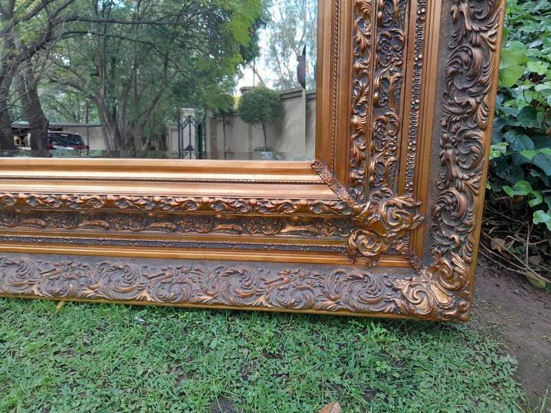 A 20th Century Heavily Carved And Bevelled Framed Mirror Of Large Proportions