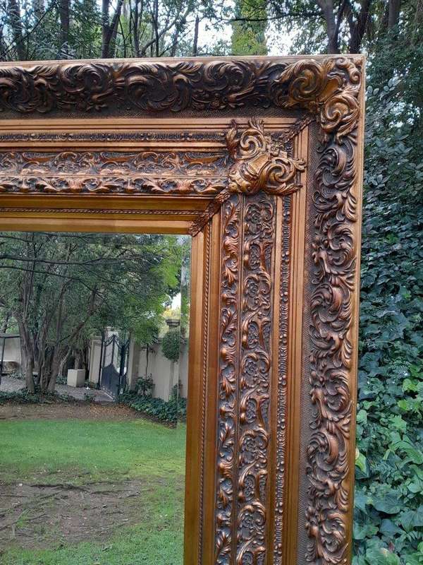 A 20th Century Heavily Carved And Bevelled Framed Mirror Of Large Proportions