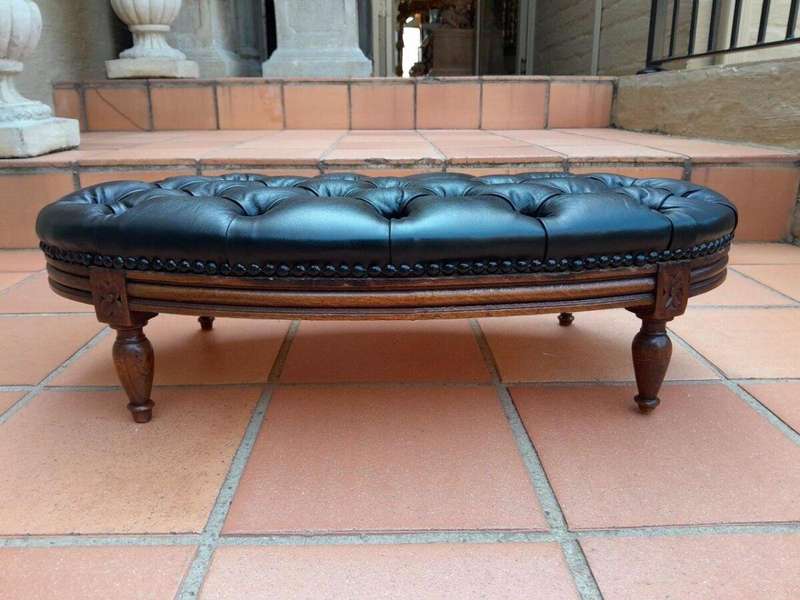A 20th Century French Style Carved Beechwood Foot Stool Upholstered In Deep Buttoned Leather