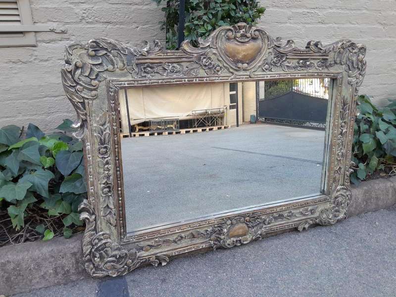 A 20th Century Victorian Style Heavily Carved Gilt And Green Mirror