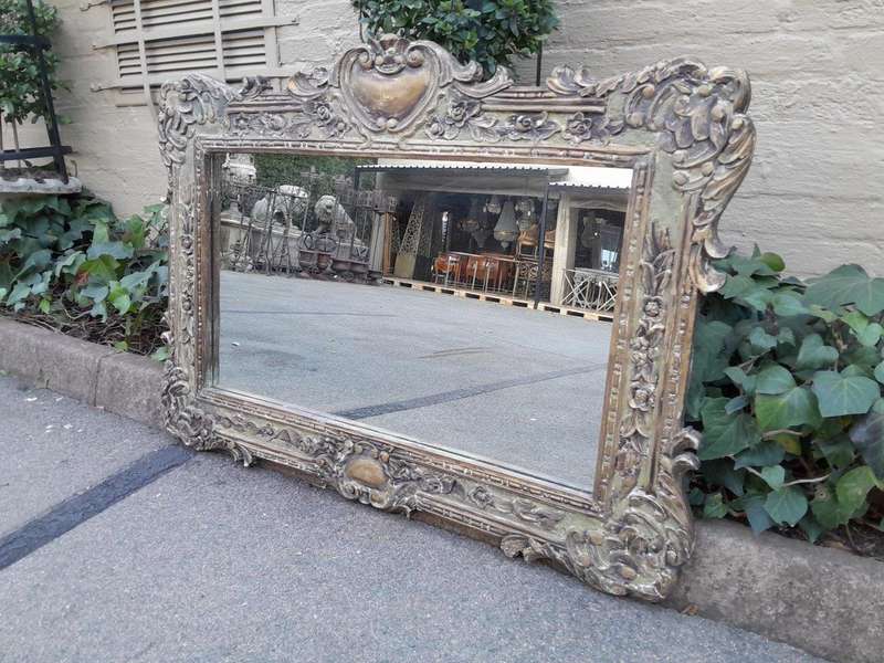 A 20th Century Victorian Style Heavily Carved Gilt And Green Mirror
