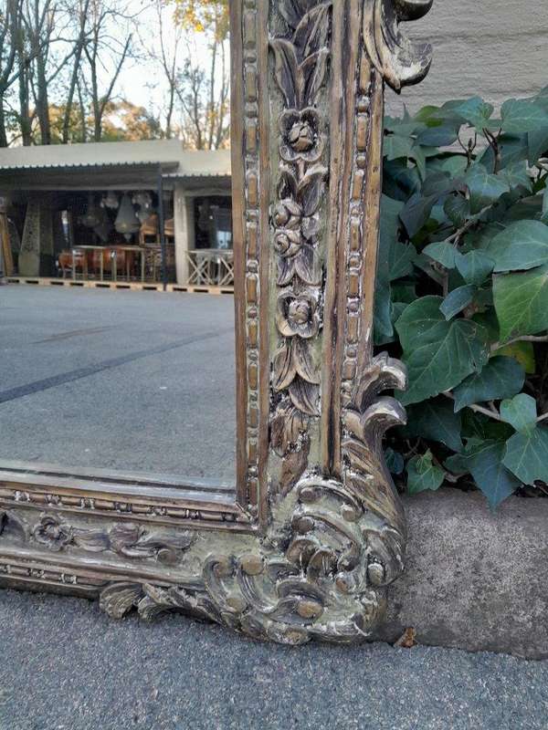 A 20th Century Victorian Style Heavily Carved Gilt And Green Mirror