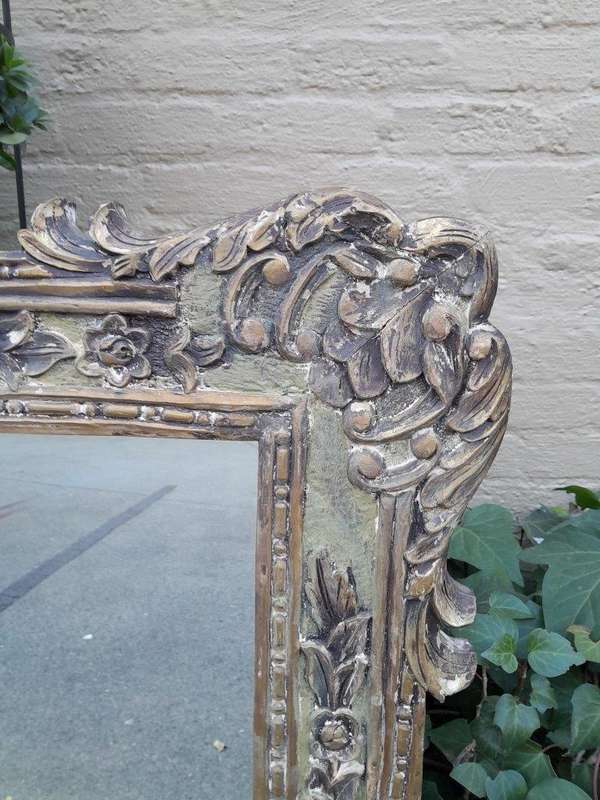 A 20th Century Victorian Style Heavily Carved Gilt And Green Mirror