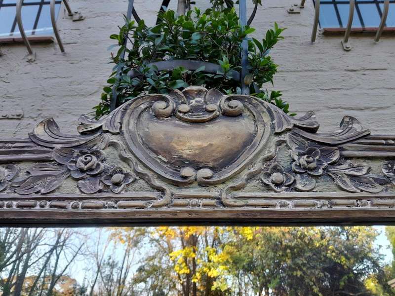 A 20th Century Victorian Style Heavily Carved Gilt And Green Mirror