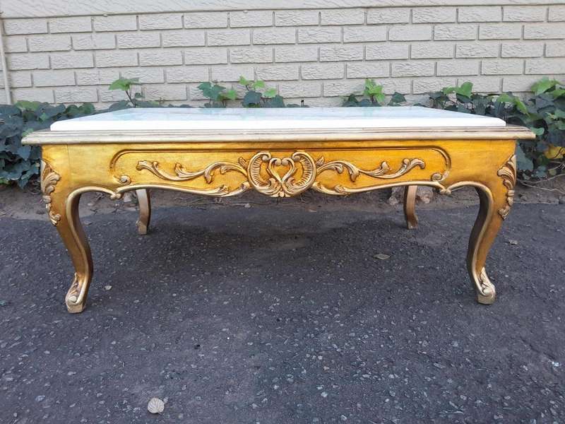 A 20th Century French Style Carved And Gilt Wood Coffee Table With Cream Marble Top
