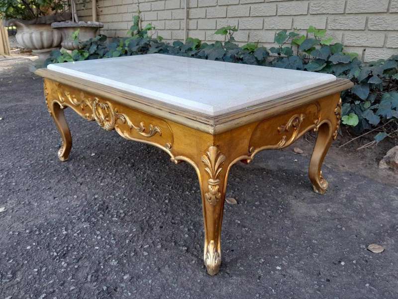 A 20th Century French Style Carved And Gilt Wood Coffee Table With Cream Marble Top