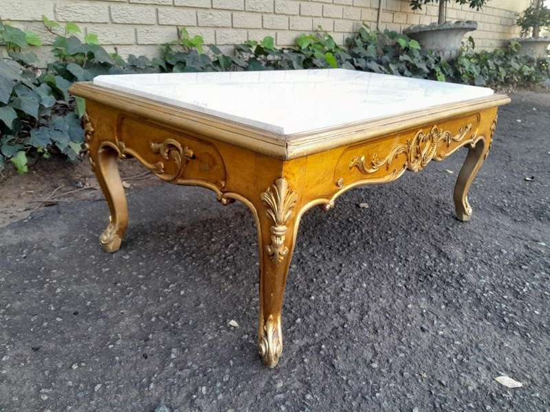 A 20th Century French Style Carved And Gilt Wood Coffee Table With Cream Marble Top