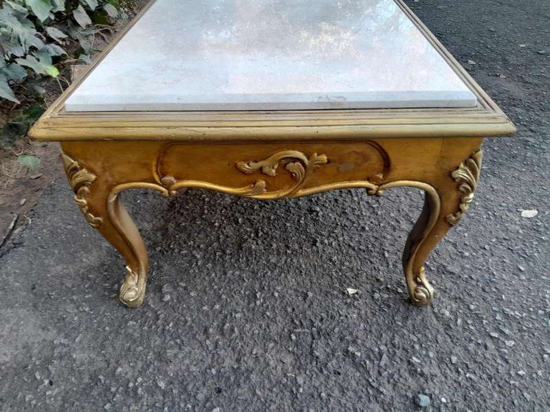 A 20th Century French Style Carved And Gilt Wood Coffee Table With Cream Marble Top