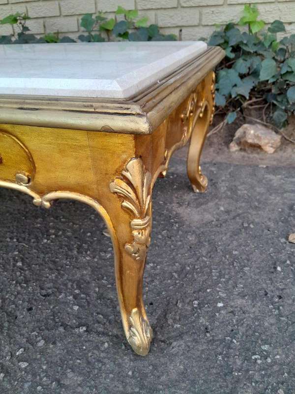 A 20th Century French Style Carved And Gilt Wood Coffee Table With Cream Marble Top