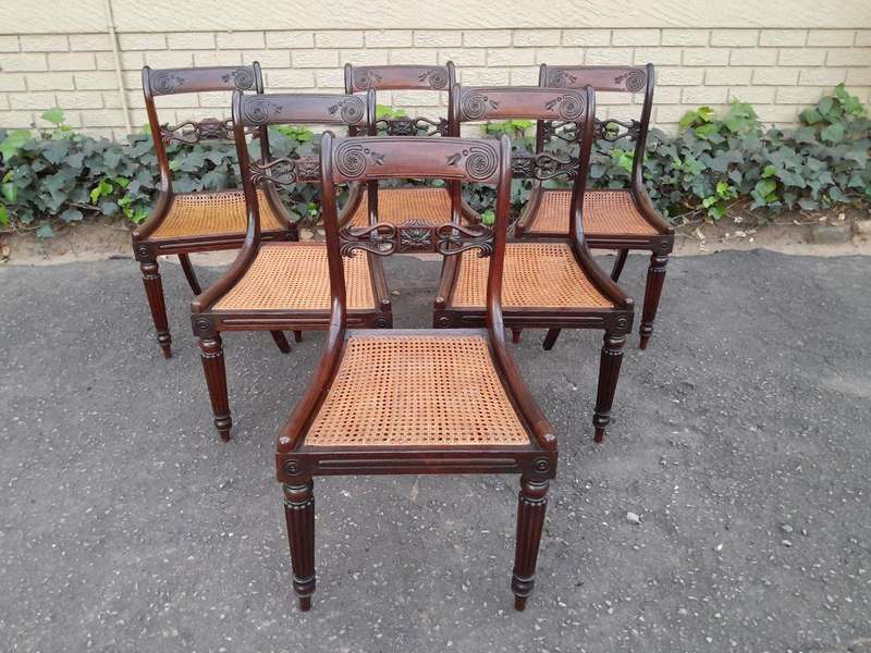 An Antique Regency Carved Rosewood Set Of Chairs With Rattan Seats And Upholstered Designer Fabri...