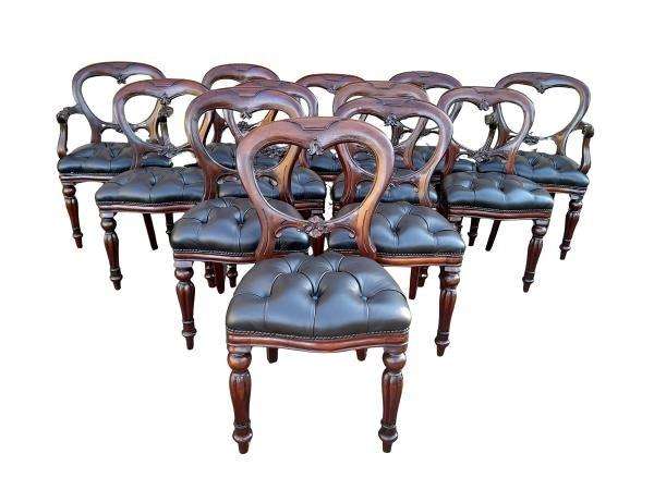 A 20th Century Set Of Twelve Teak Wood Bustle Back Chairs Comprising A Pair Of Carvers / Armchair...