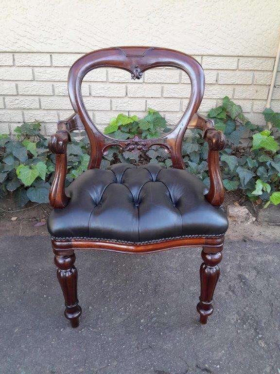 A 20th Century Set Of Twelve Teak Wood Bustle Back Chairs Comprising A Pair Of Carvers / Armchair...
