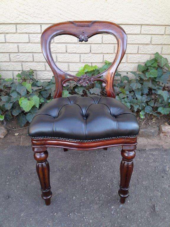 A 20th Century Set Of Twelve Teak Wood Bustle Back Chairs Comprising A Pair Of Carvers / Armchair...