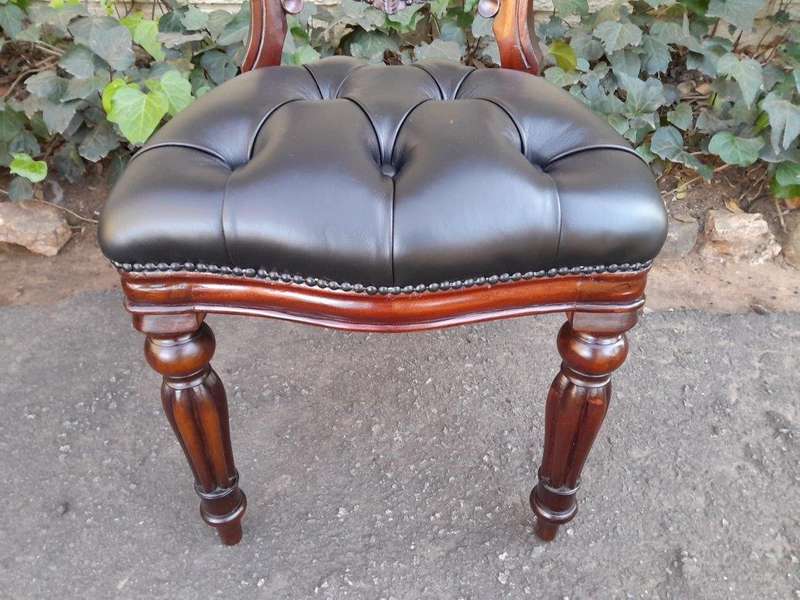 A 20th Century Set Of Twelve Teak Wood Bustle Back Chairs Comprising A Pair Of Carvers / Armchair...